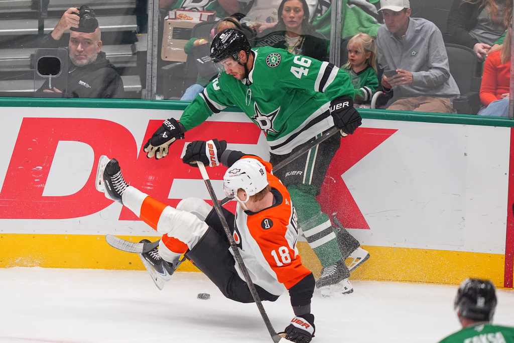 Philadelphia Flyers center Rodrigo Abols (18) falls to the ice against Dallas Stars defenseman Ilya Lyubushkin (46) during the first period of an NHL hockey game Saturday, Nov. 15, 2025, in Dallas. (AP Photo/LM Otero)
