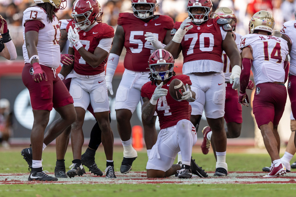 Alabama running back Daniel Hill (4) signals first down after his run against Florida State during the first half of an NCAA college football game Saturday, Sept. 19, 2026, in Tuscaloosa, Ala. (AP Photo/Vasha Hunt)