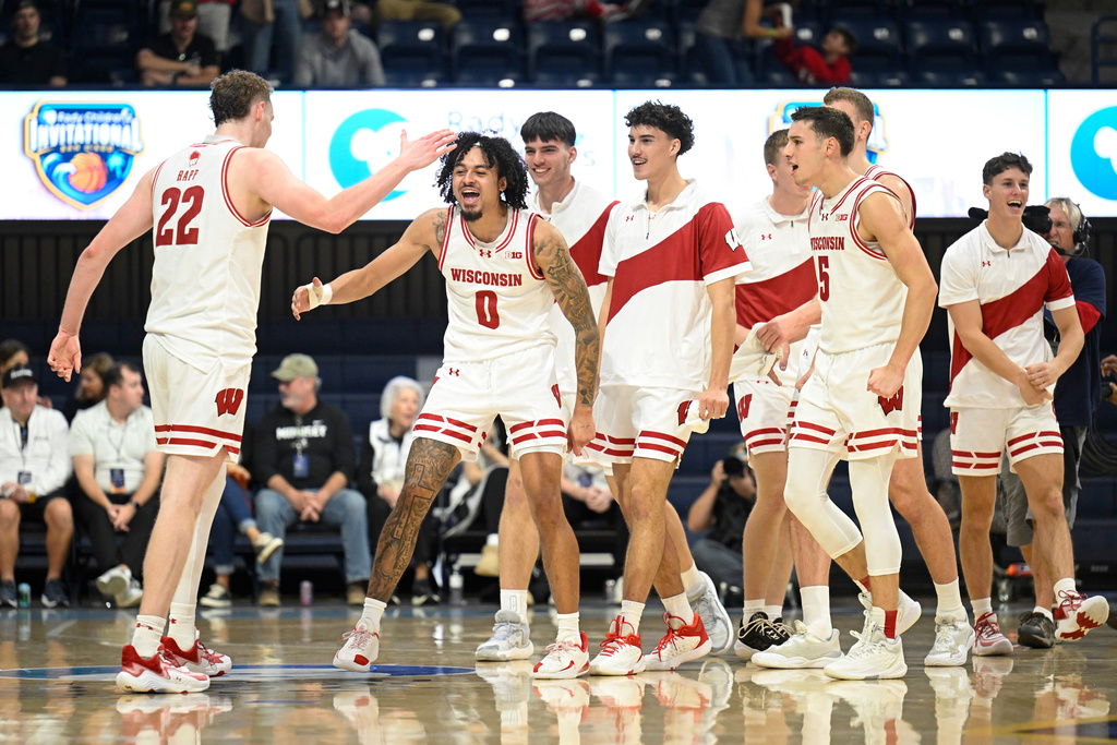 Wisconsin players celebrate at the end of the first half of an NCAA college basketball game in the Rady Children's Invitational tournament against Providence, Thursday, Nov. 27, 2025, in San Diego. (AP Photo/Denis Poroy)