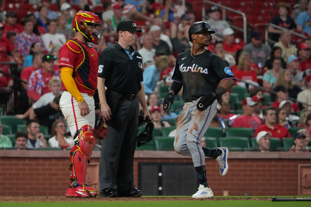 Miami Marlins' Esteury Ruiz, right, scores past St. Louis Cardinals catcher Iván Herrera, left, during the eighth inning of a baseball game Friday, June 26, 2026, in St. Louis. (AP Photo/Jeff Roberson)