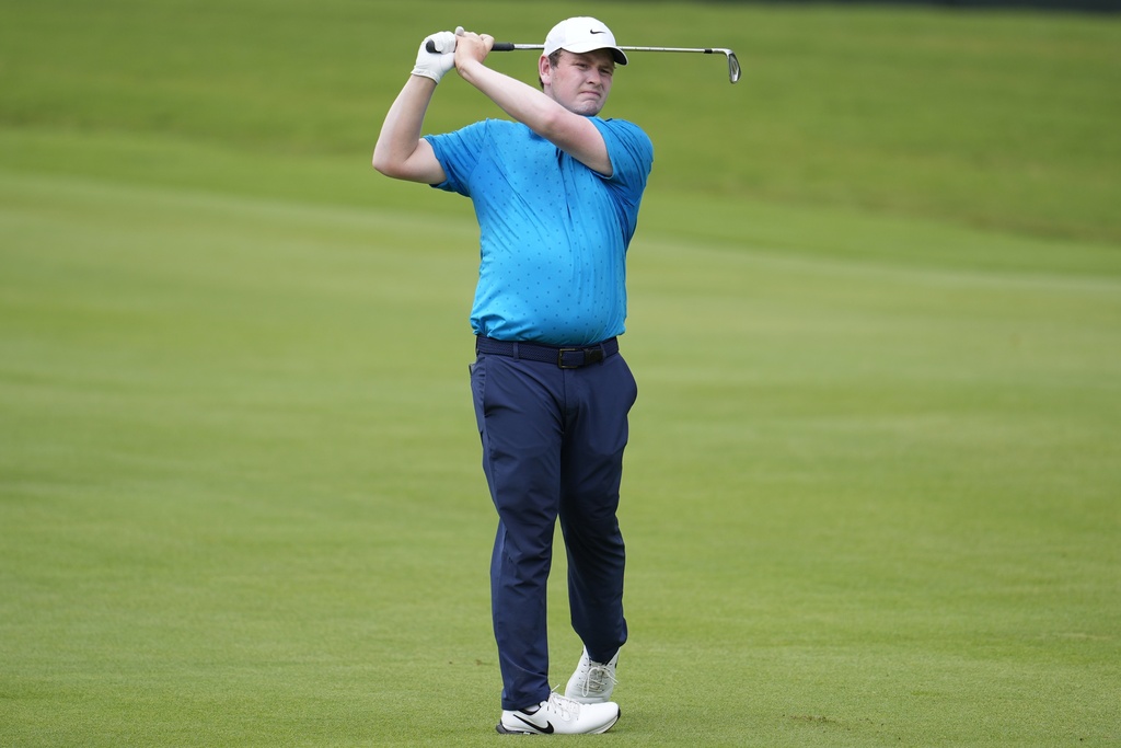 Robert Macintyre, of Scotland, hits from the first fairway during the first round of the Tour Championship golf tournament, Thursday, Aug. 21, 2025, in Atlanta. (AP Photo/Mike Stewart)