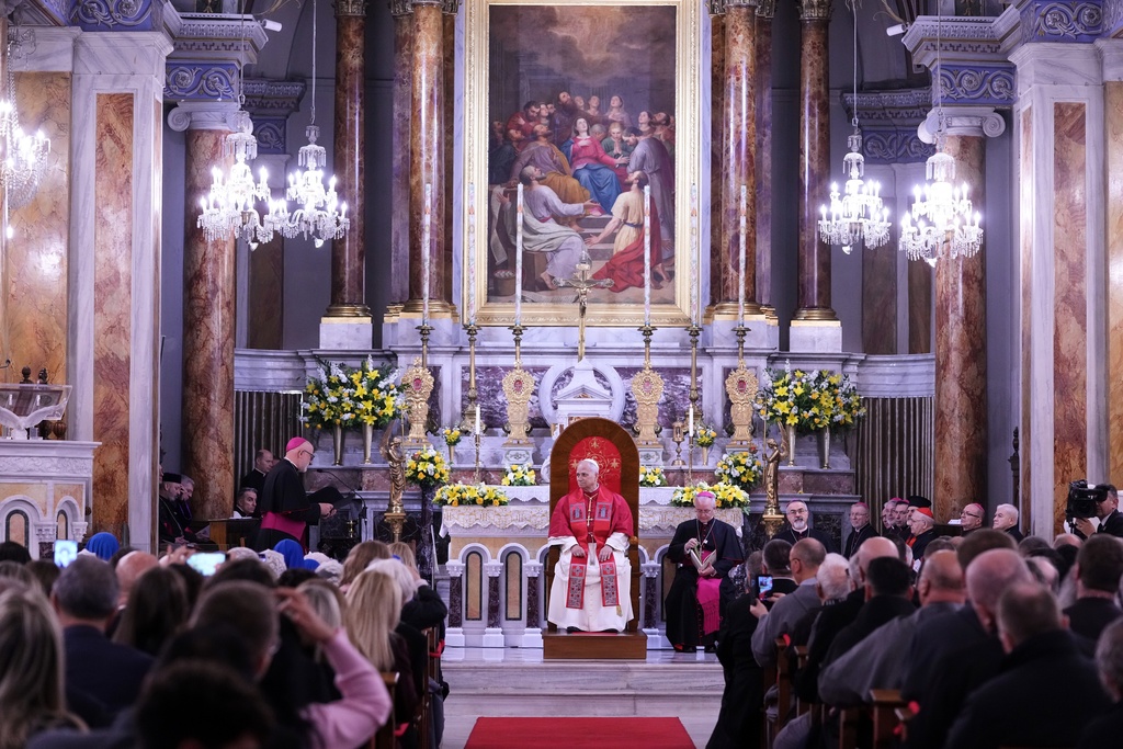 Pope Leo XIV listens as Archbishop Martin Kmetec of Izmir delivers his speech during a meeting with the clergy at the Cathedral of the Holy Spirit, in Istanbul, Turkey, Friday, Nov. 28, 2025. (AP Photo/Domenico Stinellis)