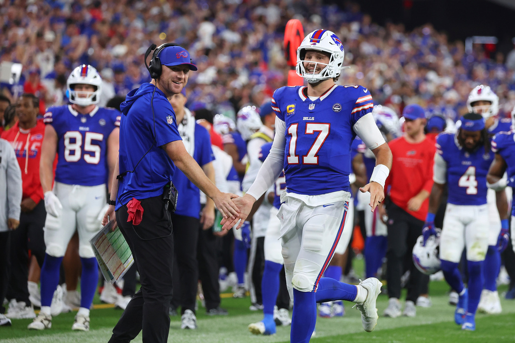 Buffalo Bills head coach Joe Brady, left, and quarterback Josh Allen (17) celebrate a touchdown against the Detroit Lions during the first half of an NFL football game in Orchard Park, N.Y., Thursday, Sept. 17, 2026. (AP Photo/Jeffrey T. Barnes )