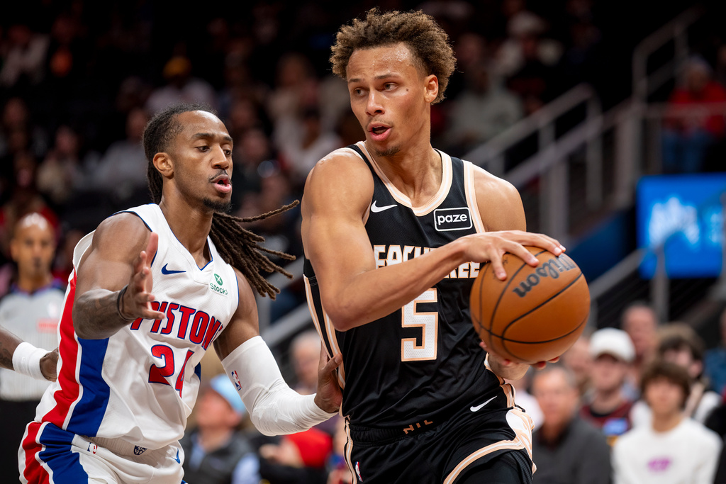 Atlanta Hawks guard Dyson Daniels (5) drives the ball against Detroit Pistons guard Daniss Jenkins during the first half of an NBA basketball game, Tuesday, Nov. 18, 2025, in Atlanta. (AP Photo/Erik Rank)