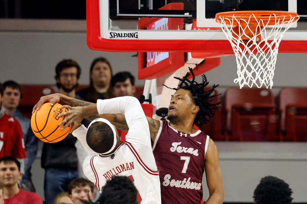 Texas Southern's Zaire Hayes (7) blocks the shot of North Carolina State's Tre Holloman (5) during the first half of an NCAA college basketball game in Raleigh, N.C., Wednesday, Dec. 17, 2025. (AP Photo/Karl DeBlaker)