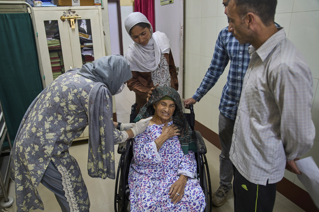 Fazi, a 60-year-old woman, grimaces as she receives a dose of vaccine after being attacked by a pack of stray dogs inside the compound of her house at the anti-rabies clinic at a hospital in Srinagar, Indian controlled Kashmir, Thursday, Sept. 18, 2025. (AP Photo/Dar Yasin)