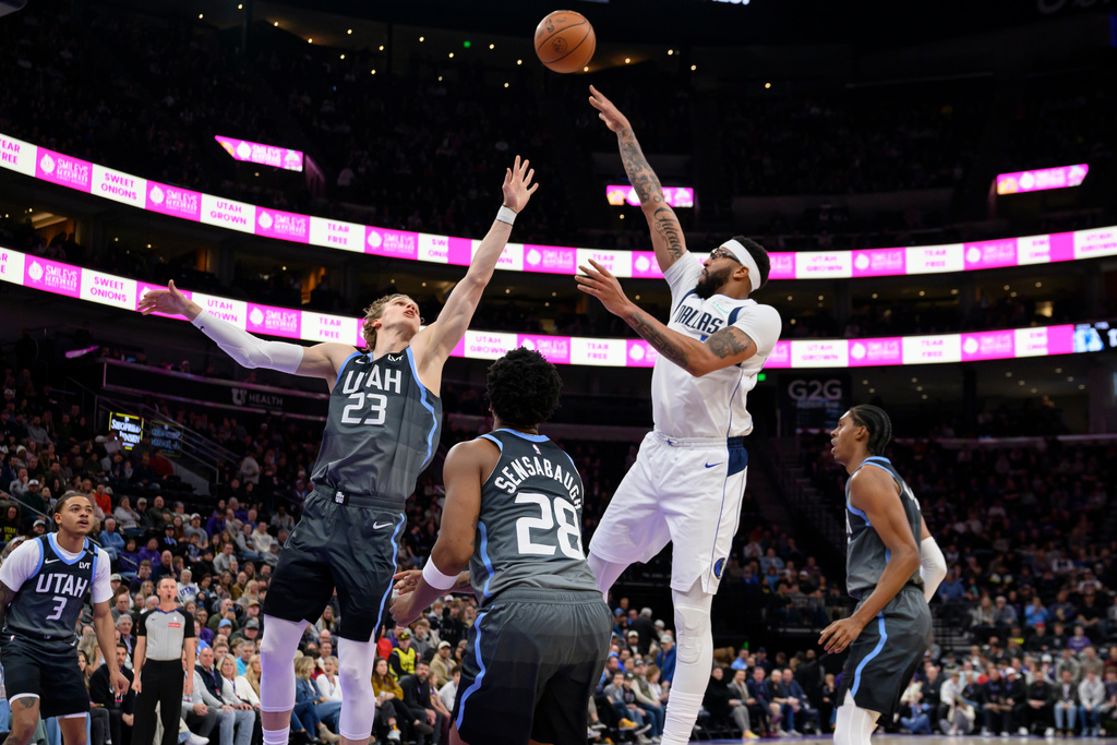 Dallas Mavericks forward Anthony Davis, center right, shoots over Utah Jazz forward Lauri Markkanen (23) during the first half of an NBA basketball game, Thursday, Jan. 8, 2026, in Salt Lake City. (AP Photo/Tyler Tate)
