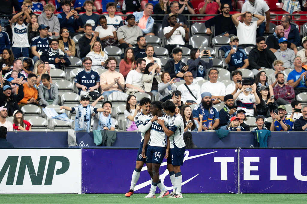 Vancouver Whitecaps' Bruno Caicedo (14) celebrates his goal against the Los Angeles Galaxy with with his teammates during the second half of an MLS soccer match in Vancouver, British Columbia, on Wednesday, Sept. 9, 2026. (Ethan Cairns/The Canadian Press via AP)