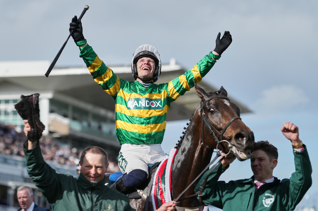 Jockey Paul Townend celebrates on I Am Maximus after winning the Grand National horse race at Aintree racecourse in Liverpool, Saturday, April 11, 2026. (AP Photo/Jon Super)