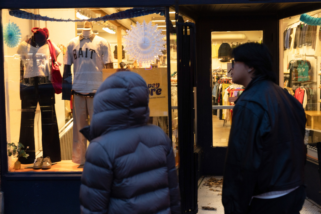People walk by a shop on Tuesday, Jan. 6, 2026, in Portland, Ore. (AP Photo/Jenny Kane)