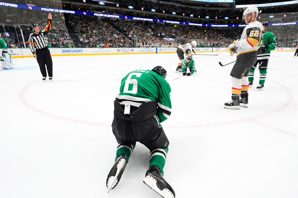 Dallas Stars defenseman Lian Bichsel (6) recovers from taking a hi-stick to the face from Vegas Golden Knights center Nic Dowd (62) in the second period of an NHL hockey game in Dallas, Tuesday, March 10, 2026. (AP Photo/Tony Gutierrez)