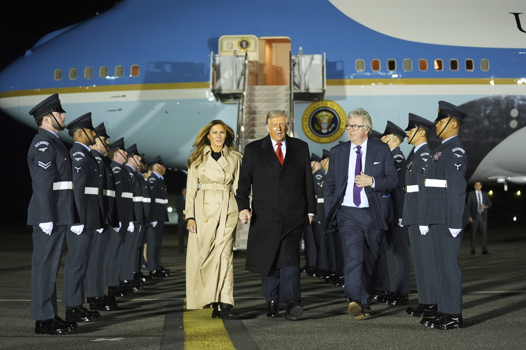 President Donald Trump and first lady Melania Trump are greeted by The Viscount Hood, Lord-in-Waiting, center, right, as they arrive at Stansted Airport near London, Tuesday, Sept. 16, 2025. (AP Photo/Evan Vucci)