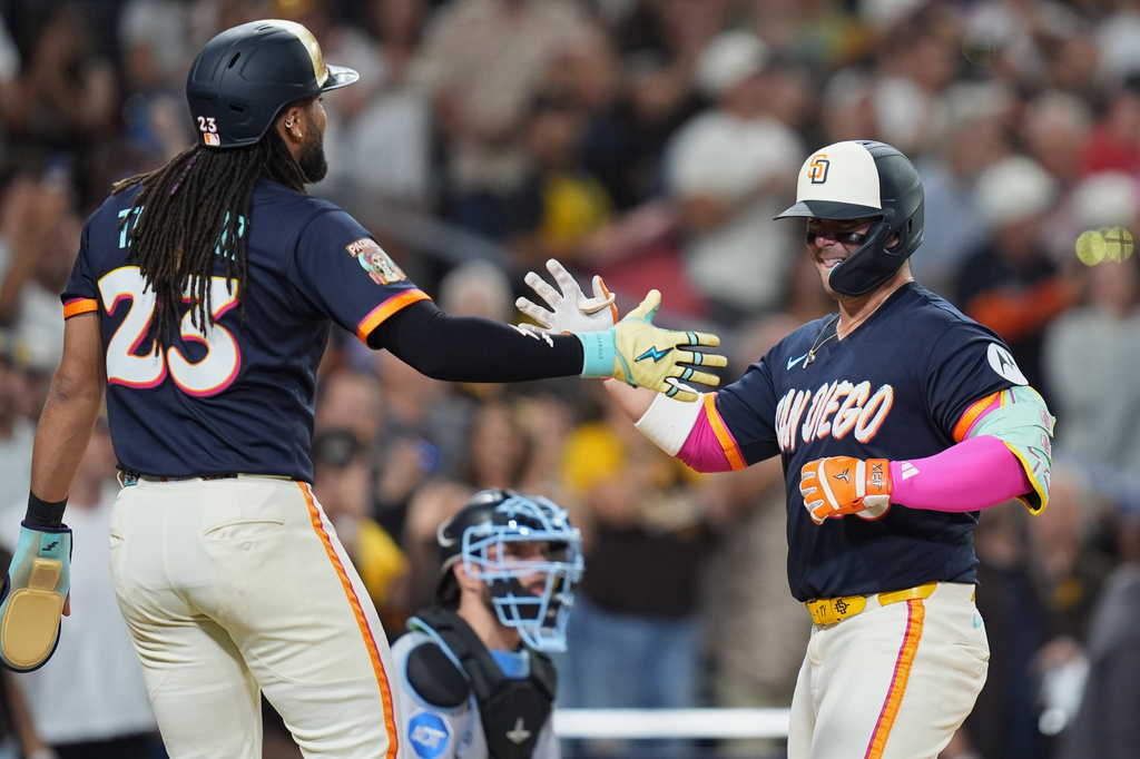 San Diego Padres' Ty France, right, celebrates with Fernando Tatis Jr. after hitting a three-run home run during the fifth inning of a baseball game against the Miami Marlins Friday, Sept. 18, 2026, in San Diego. (AP Photo/Gregory Bull)