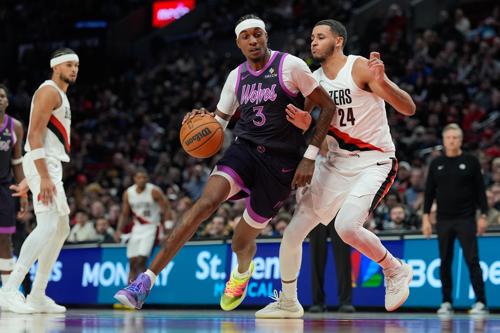 Minnesota Timberwolves forward Jaden McDaniels (3) tries to get past Portland Trail Blazers forward Kris Murray (24) during the second half of an NBA basketball game Tuesday, Feb. 24, 2026, in Portland, Ore. (AP Photo/Jenny Kane)