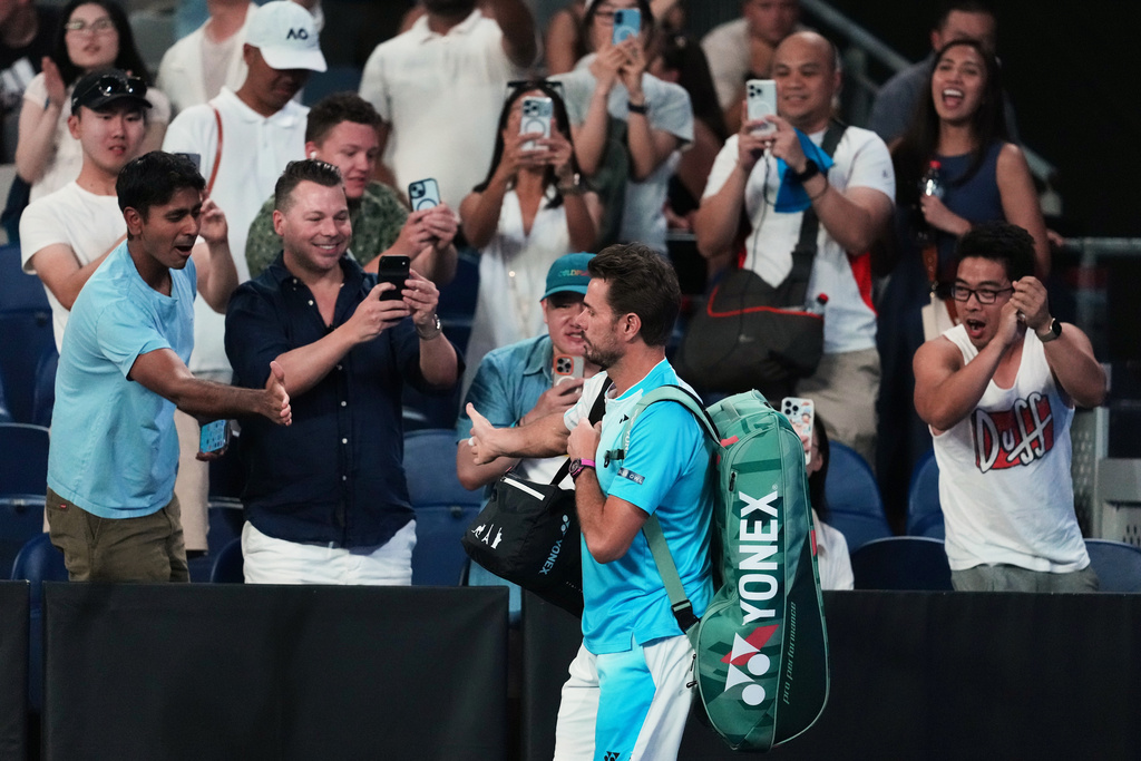 Stan Wawrinka of Switzerland gestures with fans as he walks onto court for his third round match against Taylor Fritz of the U.S. at the Australian Open tennis championship in Melbourne, Australia, Saturday, Jan. 24, 2026. (AP Photo/Asanka Brendon Ratnayake)