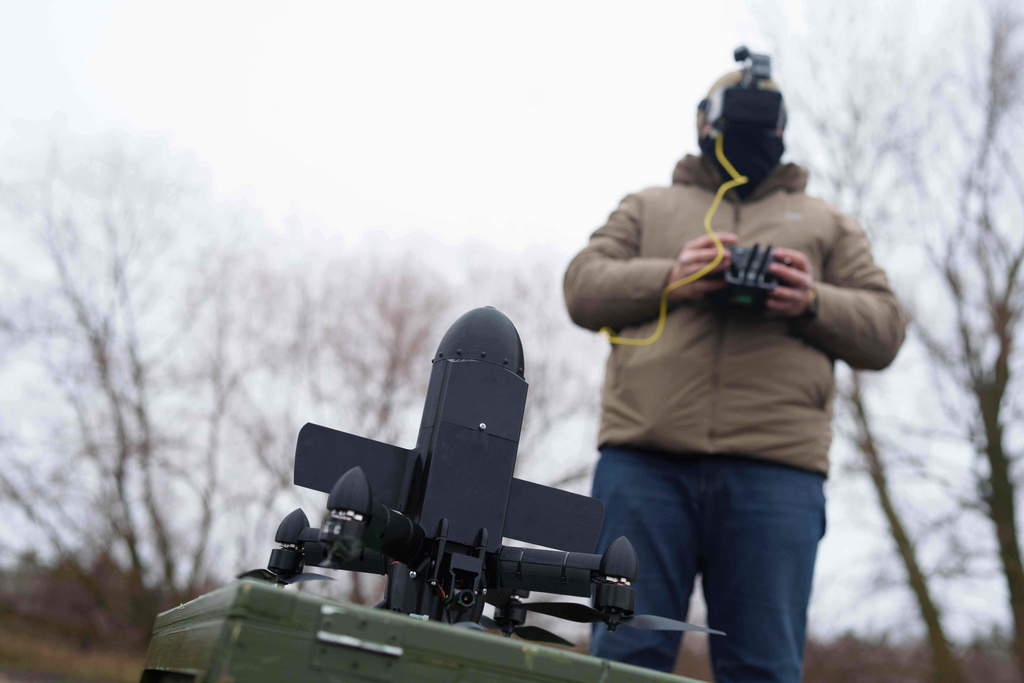 A serviceman prepares an interceptor drone of "General Cherry" company before a flight at the polygon in Ukraine, on Dec. 4, 2025. (AP Photo/Evgeniy Maloletka)
