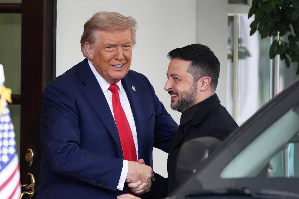 President Donald Trump, left, greets Ukraine's President Volodymyr Zelenskyy as he arrives at the White House, Monday, Aug. 18, 2025, in Washington. (AP Photo/Alex Brandon)