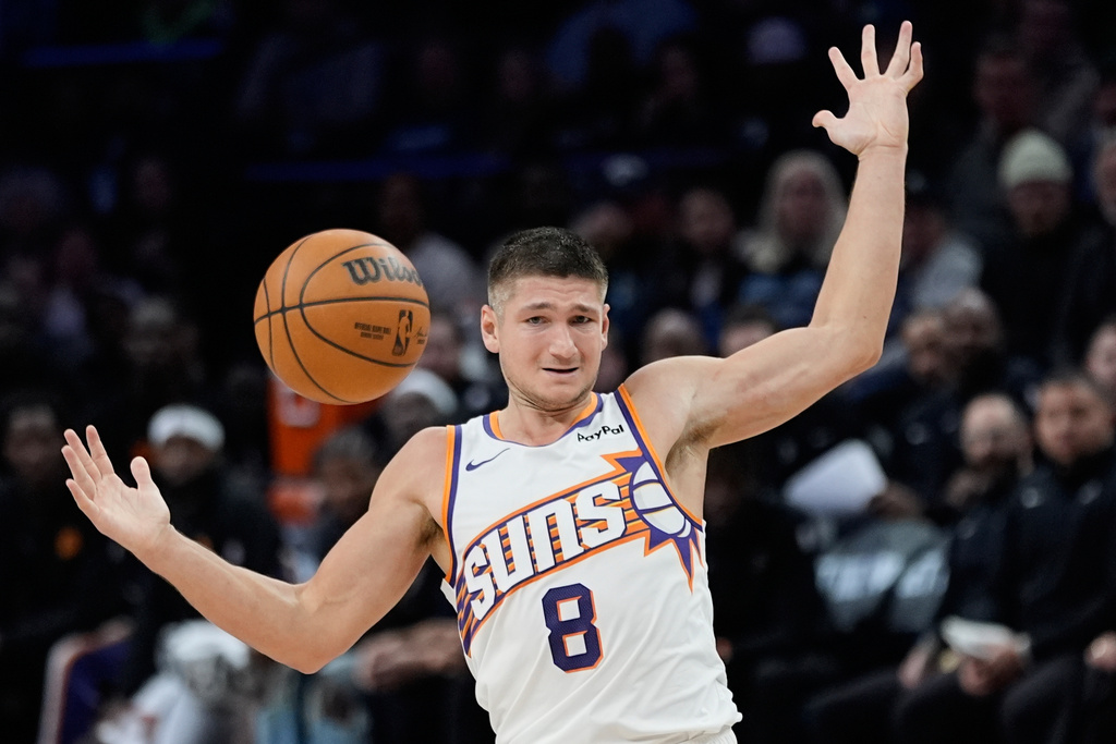 Phoenix Suns guard Grayson Allen (8) loses control of the ball during the second half of an NBA basketball game against the Minnesota Timberwolves, Monday, Dec. 8, 2025, in Minneapolis. (AP Photo/Abbie Parr)