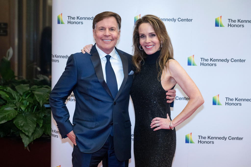 FILE - Bob Costas and Jill Costas arrive on the red carpet at the State Department for the Kennedy Center Honors gala dinner, Dec. 2, 2023, in Washington. (AP Photo/Kevin Wolf, File)