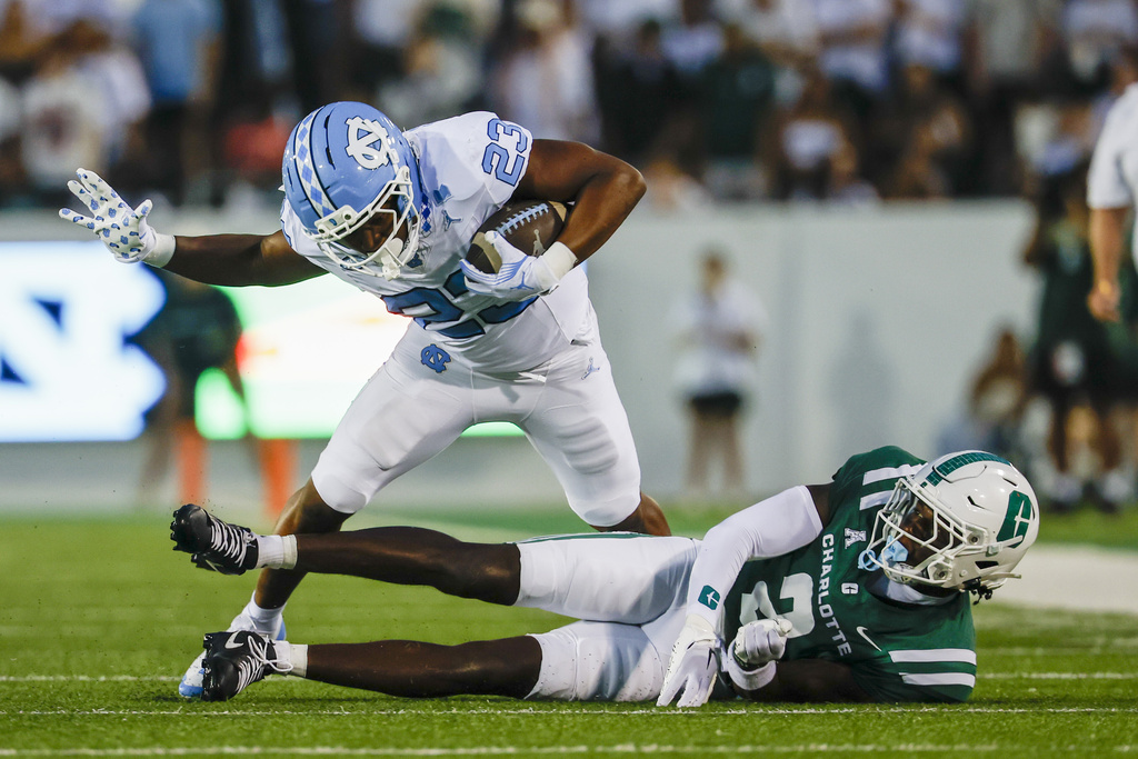 North Carolina running back Charleston French (23) fights for yards against Charlotte defensive back Treyveon McGee during the first half of an NCAA college football game in Charlotte, N.C., Saturday, Sept. 6, 2025. (AP Photo/Nell Redmond)