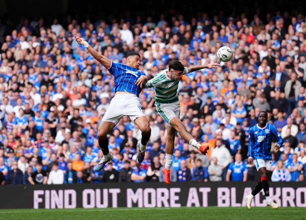 Rangers' Kevin Kelsy (left) and Celtic's Colby Donovan battle for the ball during the Scottish League Cup soccer match between Rangers and Celtic, in Glasgow, Sunday Sept. 13, 2026. (Andrew Milligan/PA via AP)