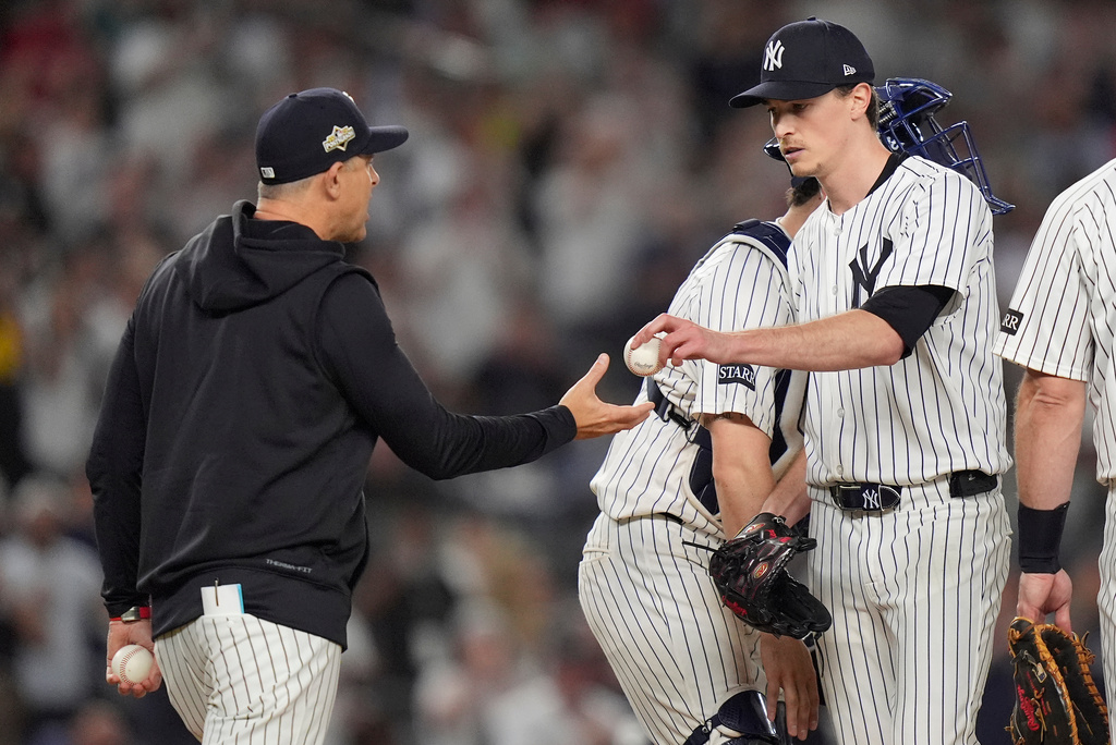 New York Yankees pitcher Max Fried, right, is relieved by manager Aaron Boone during the seventh inning of Game 1 of an American League wild-card baseball playoff series against the Boston Red Sox, Tuesday, Sept. 30, 2025, in New York. (AP Photo/Frank Franklin II)