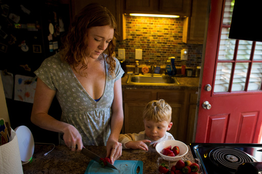 Taylor Moyer slices strawberries as her youngest son, Bradley, helps put the sliced fruit into a bowl while at home in the kitchen, Sunday, Oct. 5, 2025, in Virginia Beach, Va. (AP Photo/John Clark) Taylor Moyer slices strawberries as her youngest son, Bradley, helps put the sliced fruit into a bowl while at home in the kitchen, Sunday, Oct. 5, 2025, in Virginia Beach, Va. (AP Photo/John Clark)