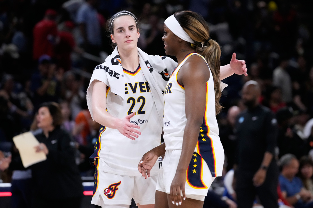 Indiana Fever guard Caitlin Clark, left, celebrates with guard Raven Johnson after the Feaver defeated the Chicago Sky in a WNBA basketball game Sunday, Aug. 23, 2026, in Chicago. (AP Photo/Nam Y. Huh)