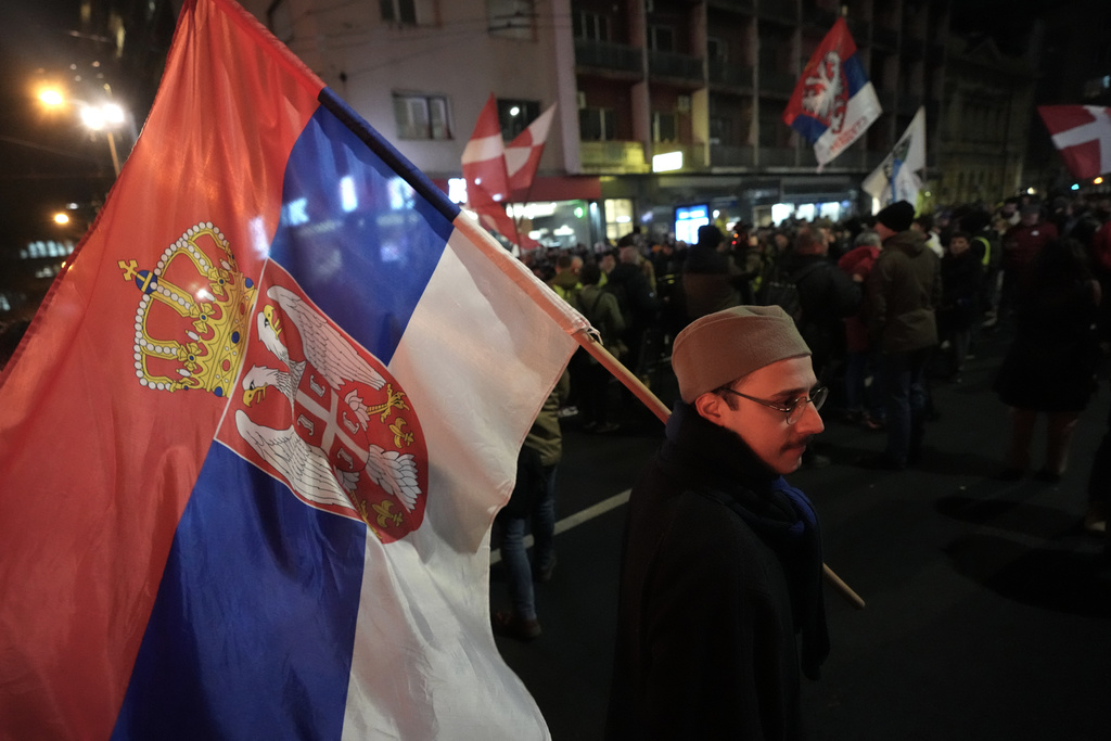 People attend a protest against a government crackdown on universities in Belgrade, Serbia, Tuesday, Jan. 27, 2026. (AP Photo/Darko Vojinovic)