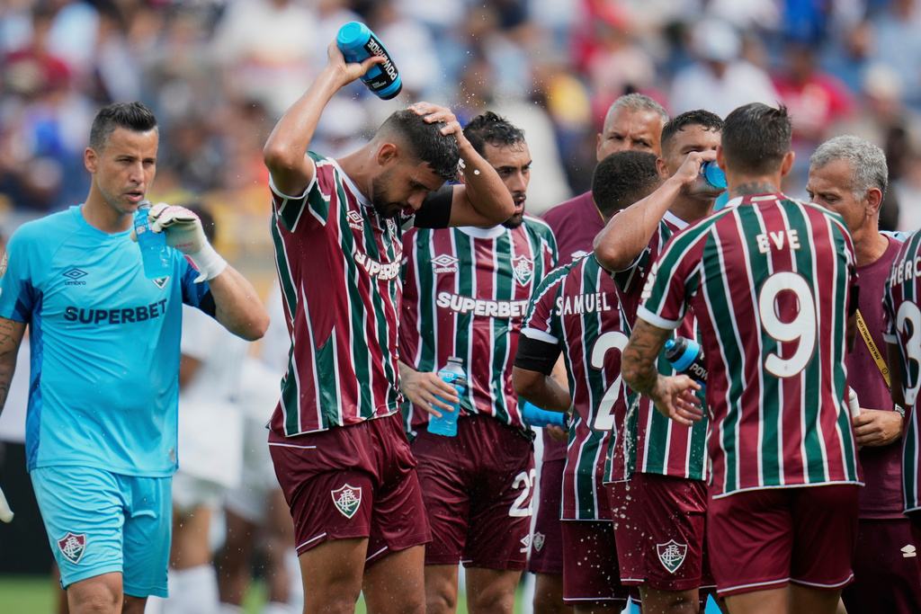 FILE - Fluminense players cooling up during a water break at the Club World Cup quarterfinal soccer match between Fluminense and Al Hilal in Orlando, Fla., Friday, July 4, 2025. (AP Photo/John Raoux, file)