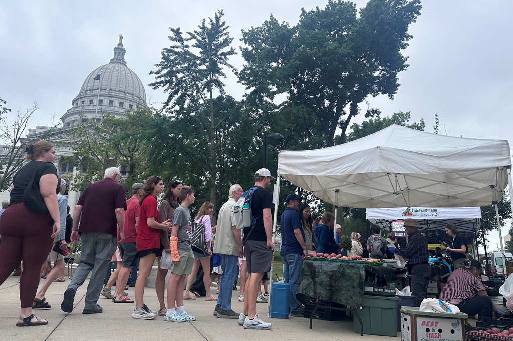 Shoppers line up at the farmers market outside of the Wisconsin state Capitol on Saturday, July 26, 2026, in Madison, Wis. (AP Photo/Scott Bauer)