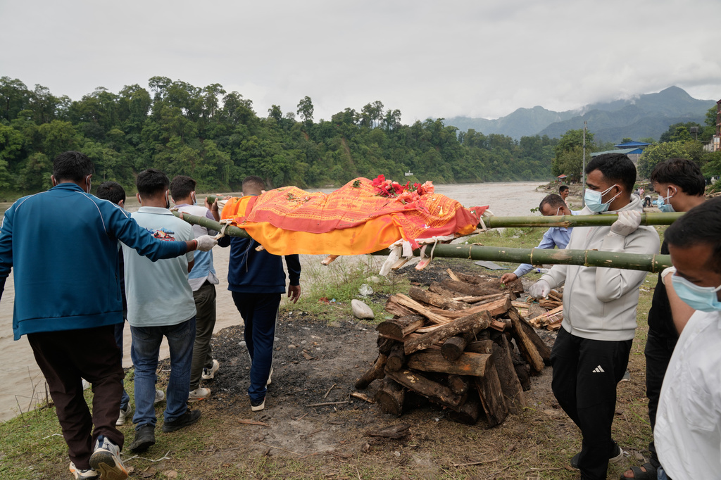 Relatives and friends cremate Aayush Khada who was killed in flash floods, in Chitwan, Nepal, Monday, Aug. 31, 2026. (AP Photo/Dar Yasin)