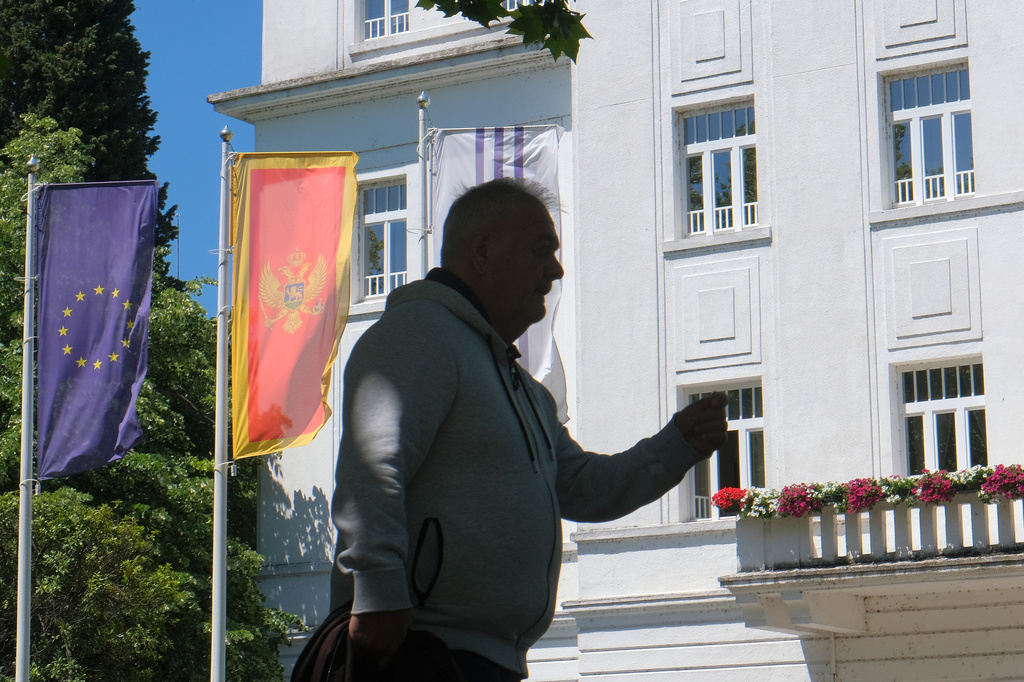 A man walks on a street in Montenegro's capital Podgorica, Monday, May 18, 2026. (AP Photo/Risto Bozovic)