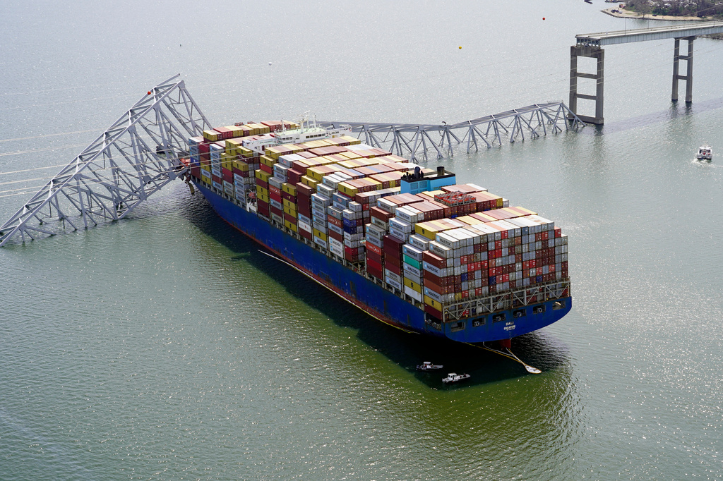 FILE - In this aerial image released by the Maryland National Guard the cargo ship Dali is stuck under part of the structure of the Francis Scott Key Bridge after the cargo ship hit the bridge, March 26, 2024, in Baltimore. (Maryland National Guard via AP)