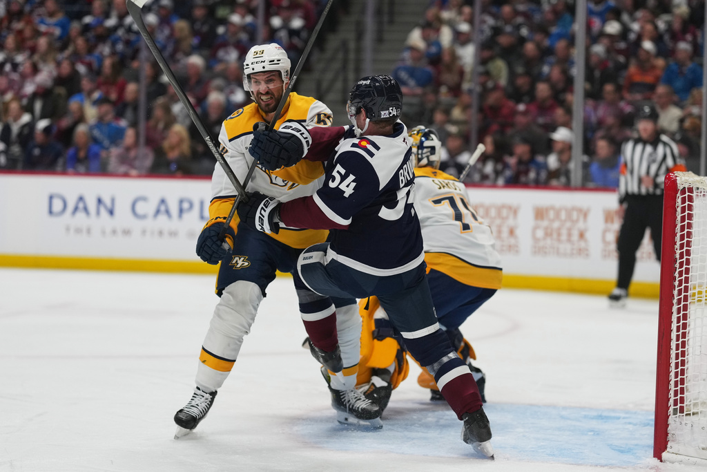 Nashville Predators defenseman Roman Josi, left, battles for position with Colorado Avalanche center Gavin Brindley (54) in the first period of an NHL hockey game Friday, Jan. 16, 2026, in Denver. (AP Photo/David Zalubowski)