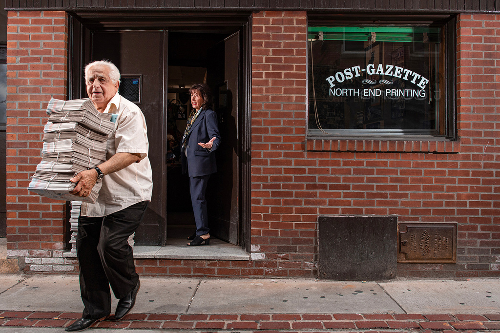 This photo provided by Ann Hermes shows Louie Graffeo delivering copies of The Post-Gazette for his girlfriend, publisher and editor, Pamela Donnaruma, in Boston on June 8, 2023. (Ann Hermes via AP)