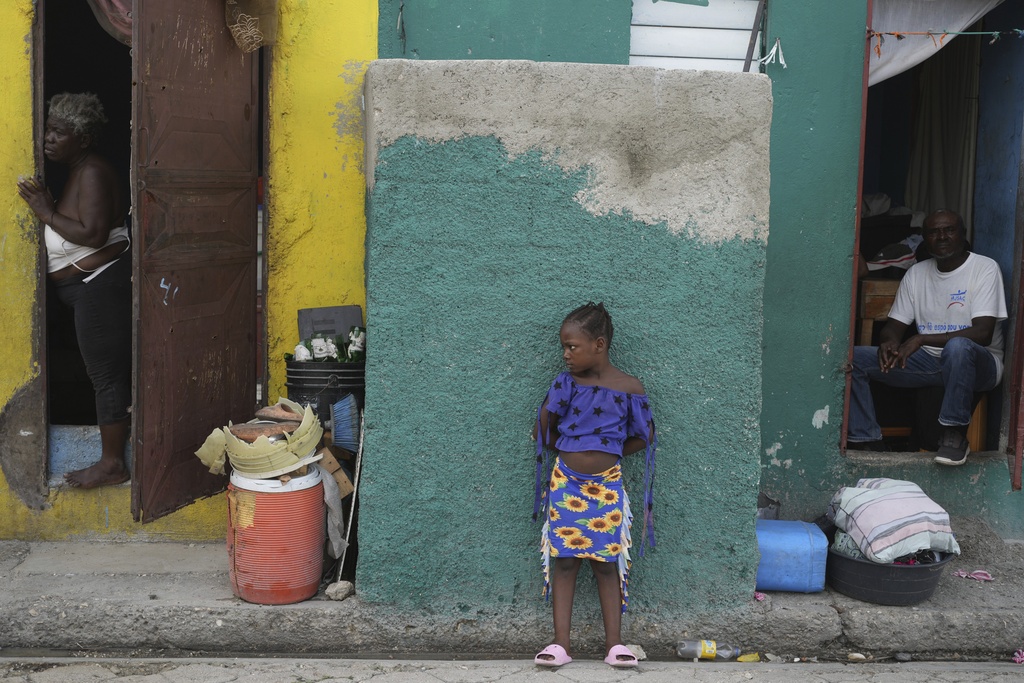 People look out at a street in the Simon-Pele neighborhood of Port-au-Prince, Haiti, Monday, Sept. 22, 2025.(AP Photo/Odelyn Joseph)