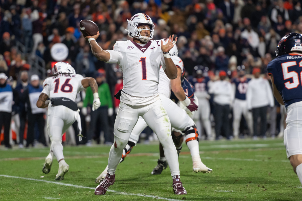 Virginia Tech quarterback Kyron Drones (1) looks to pass against Virginia during the first half of an NCAA college football game, Saturday, Nov. 29, 2025, in Charlottesville, VA. (AP Photo/Robert Simmons)