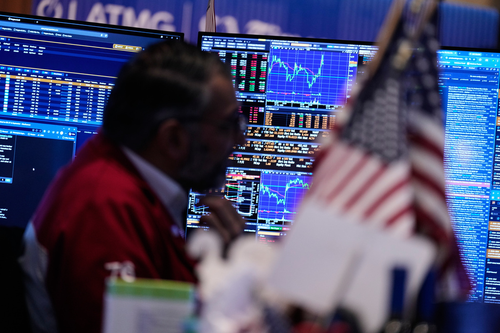 Screens display financial information on the floor at the New York Stock Exchange in New York, Tuesday, March 31, 2026. (AP Photo/Seth Wenig)