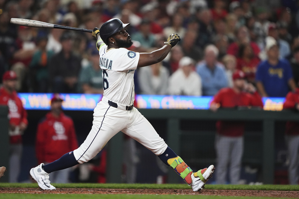 Seattle Mariners' Randy Arozarena follows through on an RBI sacrifice fly to score designated hitter Mitch Garver against the St. Louis Cardinals during the fourth inning of a baseball game Tuesday, Sept. 9, 2025, in Seattle. (AP Photo/Lindsey Wasson)
