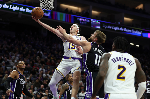 Los Angeles Lakers guard Austin Reaves, left, draws a foul on Sacramento Kings center Domantas Sabonis (11) during the first half of an NBA basketball game, Sunday, Oct. 26, 2025, in Sacramento, Calif. (AP Photo/Sara Nevis) Los Angeles Lakers guard Austin Reaves, left, draws a foul on Sacramento Kings center Domantas Sabonis (11) during the first half of an NBA basketball game, Sunday, Oct. 26, 2025, in Sacramento, Calif. (AP Photo/Sara Nevis)