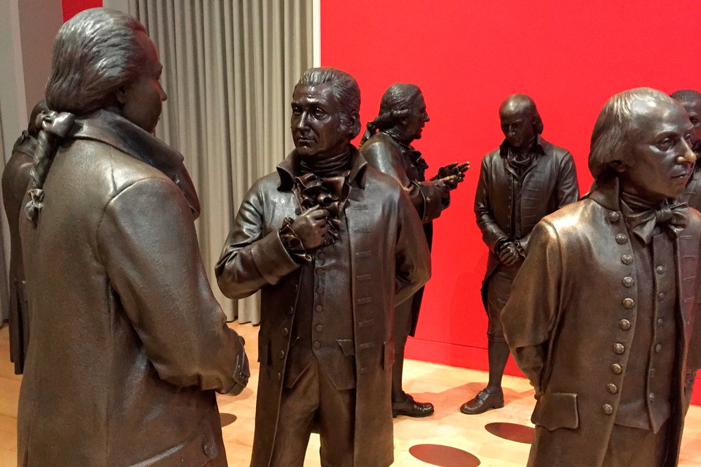 FILE - Life-size bronze sculptures of the signers of the U.S. Constitution stand in the Signers' Hall on July 7, 2016, at the National Constitution Center in Philadelphia. (AP Photo/Beth J. Harpaz, File)