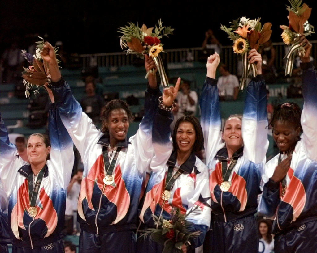 FILE - United States' women's basketball team members, fromleft, from left are: Jennifer Azzi, Lisa Leslie, Carla McGhee, Katy Steding and Sheryl Swoopes, wear their gold medals during medal ceremonies in basketball at the Centennial Summer Olympic Games in Atlanta Sunday, August 4, 1996. (AP Photo/Susan Ragan, File)