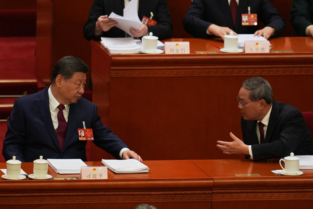 Chinese President Xi Jinping, left and Chinese Premier Li Qiang chat during the opening session of the National People's Congress (NPC) in Beijing, Thursday, March 5, 2026. (AP Photo/Ng Han Guan)