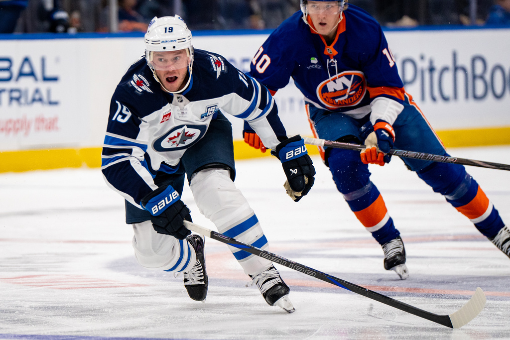 Winnipeg Jets center Jonathan Toews (19) skates upice during the third period of an NHL hockey game against the New York Islanders, Monday, Oct. 13, 2025, in Elmont, N.Y. (AP Photo/Angelina Katsanis)
