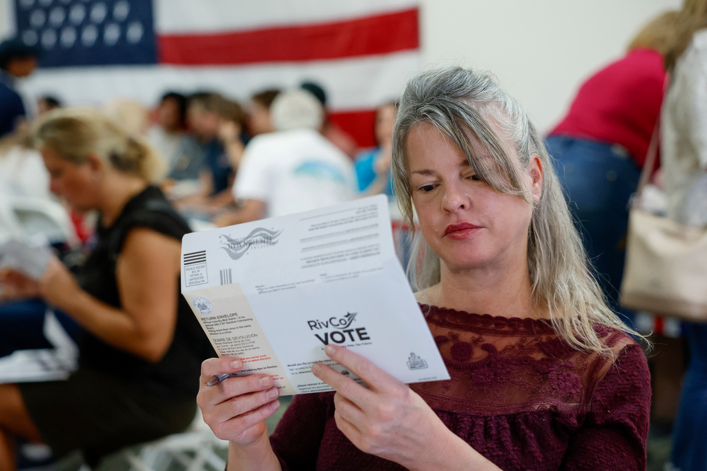 Tiffany Valencia, a Riverside County resident, fills out a primary election ballot during a "Barbeque, Beer and Ballots" event organized by Reform California on Saturday, May 9, 2026, in Corona, Calif. (AP Photo/Caroline Brehman)