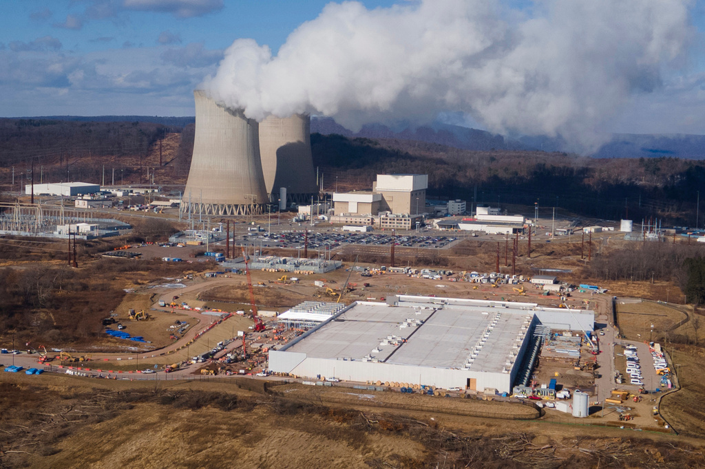 FILE - A data center owned by Amazon Web Services, front right, is under construction next to the Susquehanna nuclear power plant in Berwick, Pa., Jan. 14, 2025. (AP Photo/Ted Shaffrey, File)