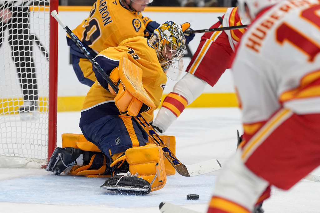 Nashville Predators goaltender Juuse Saros (74) defends during the first period of an NHL hockey game against the Calgary Flames, Saturday, Nov. 1, 2025, in Nashville, Tenn. (AP Photo/Camden Hall)