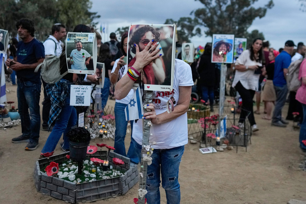 People visit the site of the Nova music festival, where hundreds of revelers were killed and abducted by Hamas and taken into Gaza, on the one-year anniversary of the attack, near Kibbutz Reim, southern Israel, Monday, Oct. 7, 2024. (AP Photo/Ohad Zwigenberg)