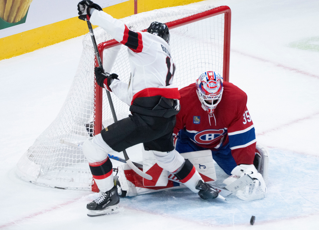 Montreal Canadiens goaltender Sam Montembeault (35) stops a shot by Ottawa Senators' Drake Batherson (19) during the second period of an NHL hockey game in Montreal, Saturday, Nov. 1, 2025. (Christinne Muschi/The Canadian Press via AP)